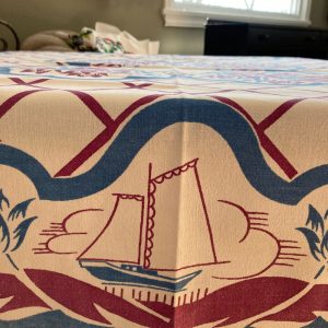 Whimsical vintage  tablecloth  of “Dutch Kids” frolicking on the shore. Purple  and blue tulips abound.