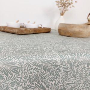 Coated tablecloth. Green foliage.